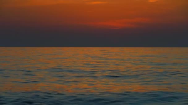 Sunset sky over sea in evening with colorful clouds of orange sunlight. — Stock video