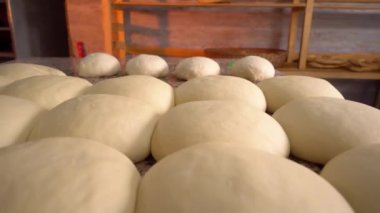 Close-up of finished pink dough in bakery on wooden table.