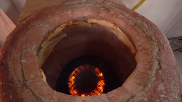 Baker making Turkish lavash in tandoor, clay oven. Baking process. — Video