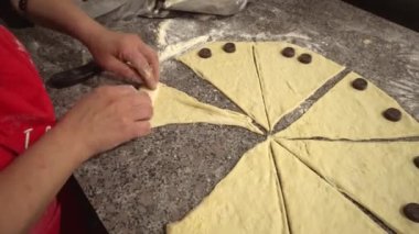 woman twisting pieces and prepare croissant