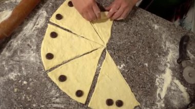 woman twisting pieces and prepare croissant