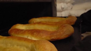 Baker ekmeği kürekle fırına atar..