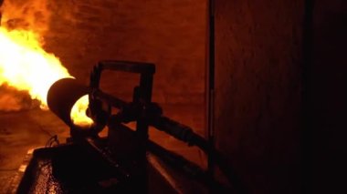 Production oven for making bread. Bakery. Large powerful fire cannon running