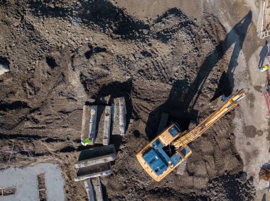 Drone view of a construction site, excavator, tractor. Aerial photography.