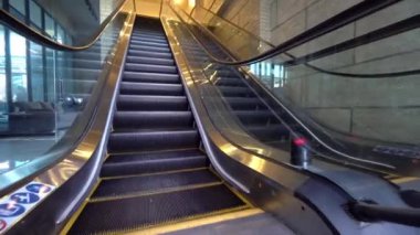 Empty escalator with no people working in mall. Epidemic or quarantine. Opening new escalator or moving staircase. Camera movement, dynamic shooting.