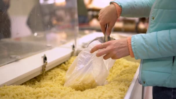 Woman Hand Puts Pasta Bag Supermarket Iron Spatula Large Transparent — ストック動画
