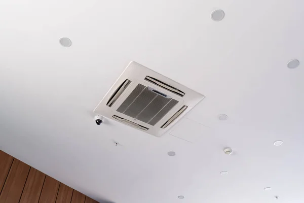 Modern ceiling cassette air conditioning system with video surveillance camera, ceiling spotlights