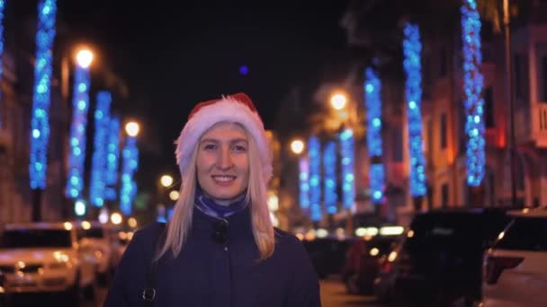 Portrait Woman Makeup Smiling Camera Playing Santa Hat Background City — Stock Video