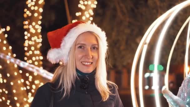 Portrait Woman Makeup Smiling Camera Playing Santa Hat Background City — Stock Video