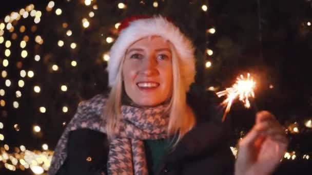 Woman Smiling Camera Playing Santa Hat Background City Lights Night — Stockvideo