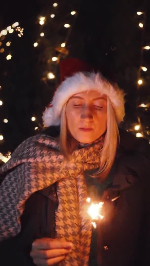 Woman Smiling Camera Playing Santa Hat Background City Lights Night — Stockvideo