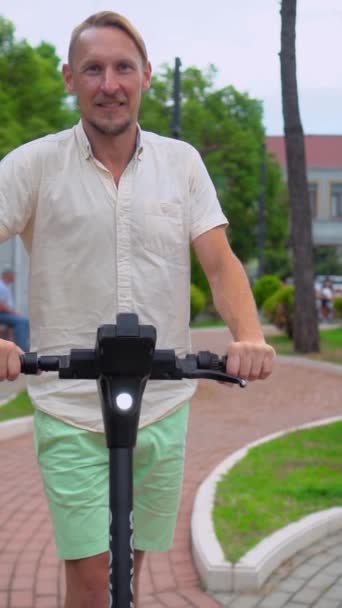 Young Man White Shirt Green Shorts Rides Electric Scooter Scooter — Stockvideo