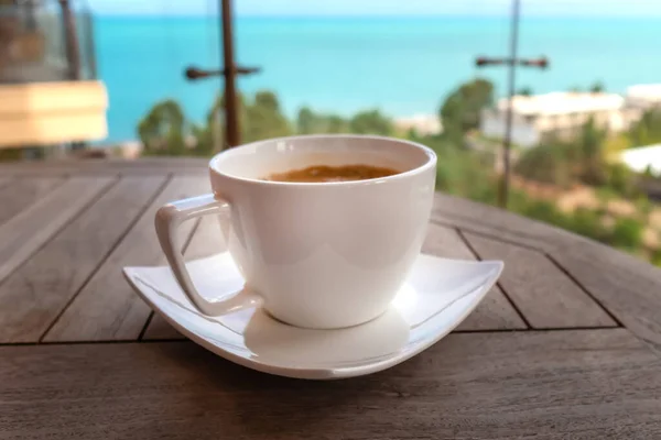 Close White Cup Coffee Wooden Table Balcony Blurred Background Sea — Stok fotoğraf