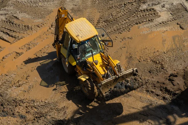 Wheel loader clears the site during excavation work on a construction site.Excavator with a front bucket removes the soil for backfilling at the construction site.Construction equipment for earthworks