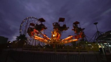 Carousel Ride Quickly rotates at sunset children's vintage. Horses and animals swing and entertain children. . Attraction - Vintage Filter Effects - Swinging Amusement Fair at amusement park at dusk.