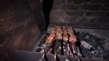 Cooking barbecue on skewers. Meat baked on coals. Chef roasts juicy beef, chicken, pork. Concept of street food. Grilled meat. Meat on grill.