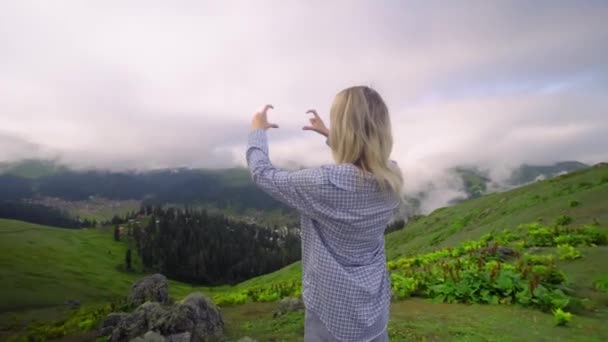 Young Girl Shows Her Heart Her Fingers Background Clouds High — Stockvideo