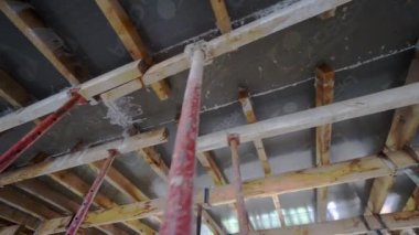 mounts on monolithic structure. Construction concept. Supports of monolithic floor formwork at construction site. Telescopic props for concrete flooring. Construction of modern apartment building