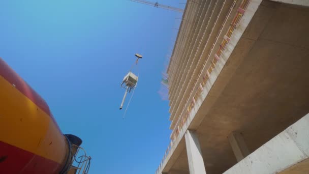 Tower Crane Lifts Cargo Form Container Concrete Top Apartment Building — Video Stock