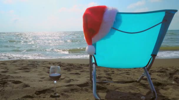 Glass Wine Chair Shizlong Santa Hat Beach Sand Backdrop Sunset — Stok video