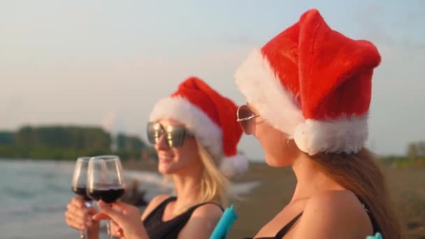 Happy Girls Bikinis Sit Chairs Celebrating Christmas Beach Drinking Wine — Vídeo de Stock