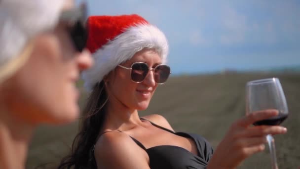 Happy Girls Bikinis Sit Chairs Celebrating Christmas Beach Drinking Wine — Wideo stockowe