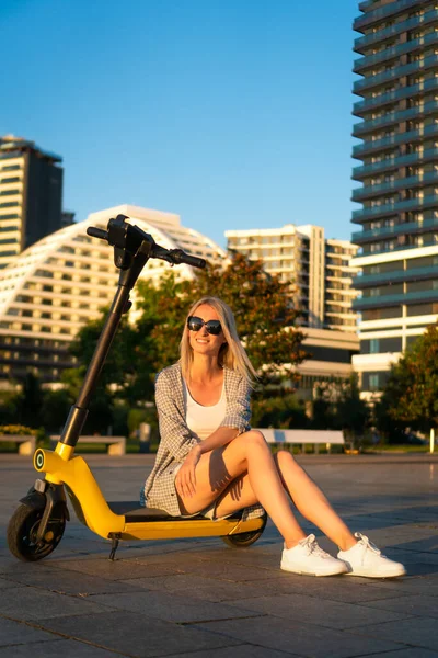 Beautiful Young Slender Blonde Woman Sunglasses Sitting Her Yellow Electric — Stock Photo, Image