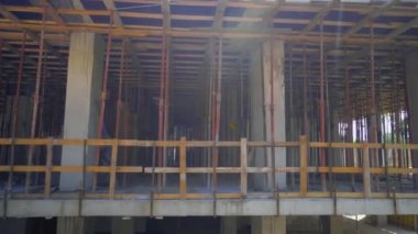 mounts on monolithic structure. Construction concept. Supports of monolithic floor formwork at construction site. Telescopic props for concrete flooring. Construction of modern apartment building