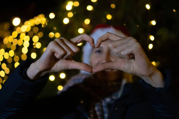 Jovem Mulher Sorridente Chapéu Papai Noel Faz Uma Forma Coração — Fotografia de Stock