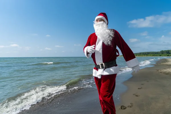 Mutlu Noel Baba Güneşli Bir Günde Denizin Kumlu Sahilinde Köpükler — Stok fotoğraf