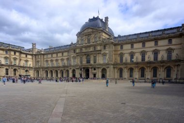 Paris, France - May 26, 2022: Front of Louvre Museum with motion blurred tourists