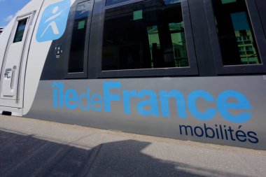 Versailles, France - May 28, 2022: Train at Versailles Rive Droite railway station showing closeup of iledeFrance logo