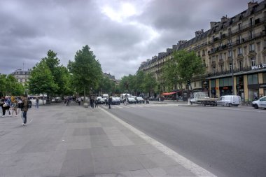 Paris, France - May 27, 2022: Street scene in Place del la Republique with traffic and motion blurred pedestrians