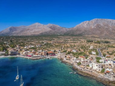 Aerial scenic view of the traditional fishing village Gerolimenas and the old port. Its one of the most picturesque settlements of Mani with crystal water and a small natural harbor in Laconia, Greece clipart