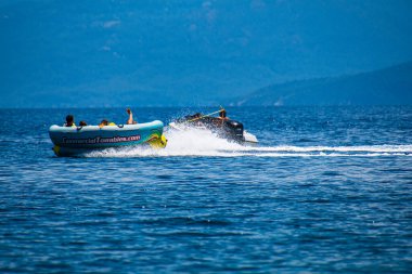 Turistler, Yunanistan 'ın Sporades adasındaki Koukounaries plajında şişirilebilir gezintilerin keyfini çıkarıyorlar