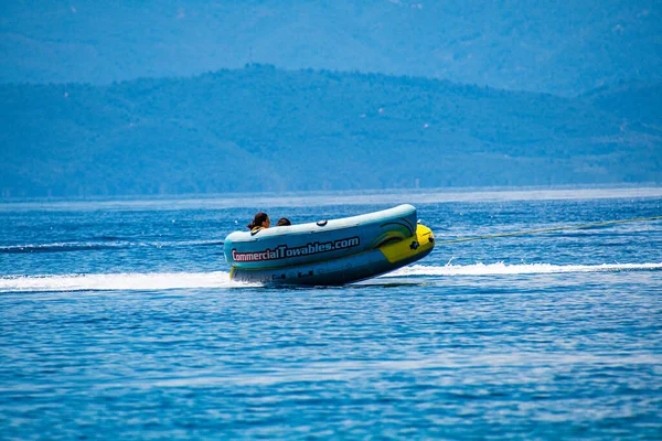 Tourists Enjoy Inflatable Towable Rides Koukounaries Beach Skiathos Island Sporades — Zdjęcie stockowe