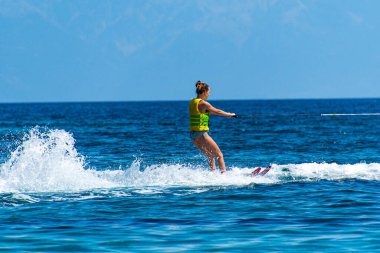Woman enjoy waterski at Koukounaries beach in Skiathos island, Sporades, Greece