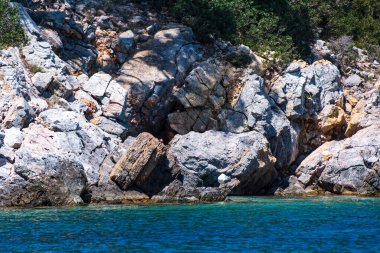 Rocky scenery around eastern Alonissos island, as seen during boating in Alonissos, Sporades, Greece