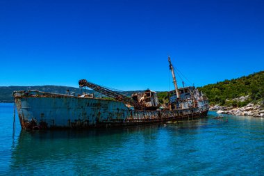 Seaside view over rusty shipwreck of an old cargo ship at Peristera island near Alonissos, Sporades, Greece