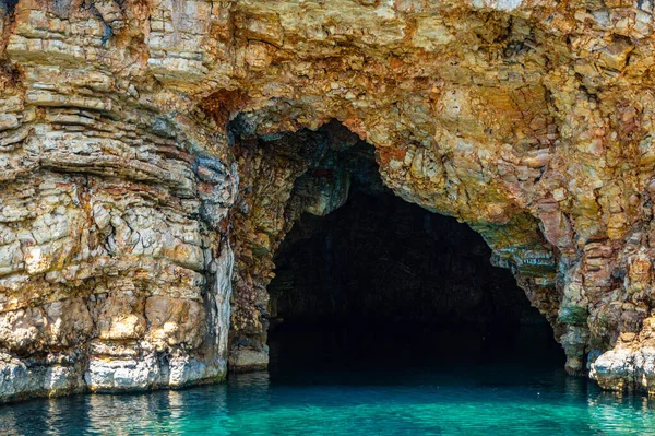 The famous caves of Votsi beach area in eastern Alonissos as seen during boating in Alonissos island, Sporades, Greece