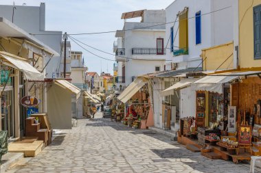 Urban view of Tinos island with narrow cobbled Streets and gift shops selling local products, souvenirs, Tinos, Cyclades Aegean Sea, Greece