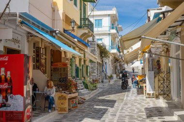 Urban view of Tinos island with narrow cobbled Streets and gift shops selling local products, souvenirs, Tinos, Cyclades Aegean Sea, Greece