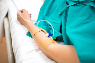 Close up view of a female hand with a dropper for intravenous injection.