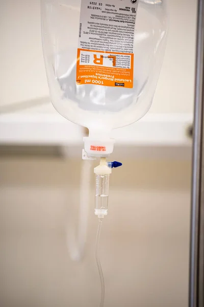 Close up saline IV drip Infusion bottle with IV solution for patient in ward hospital.
