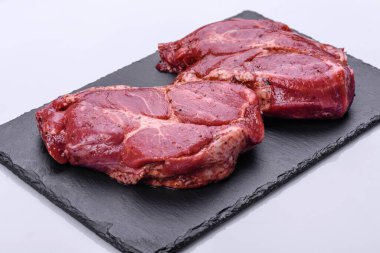 Siyah ahşap arka planda mükemmel çiğ biftek, yakın plan.