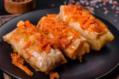 Geleneksel doldurulmuş lahana, kıyma ve pilav, domates sosunda servis edilir.