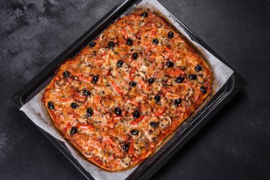 Küçük ev yapımı sebze pizzası. Yanında da domates, zeytin ve otlar.