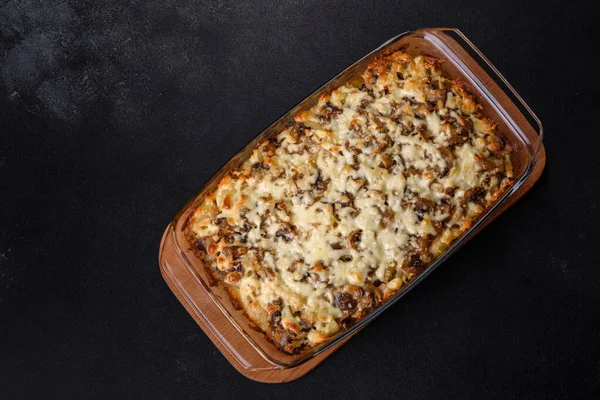 Etli, mantarlı, sebzeli ve patatesli lezzetli bir yemek. Fırında kremalı sosta pişmiş. Ev yemeği pişirmek.