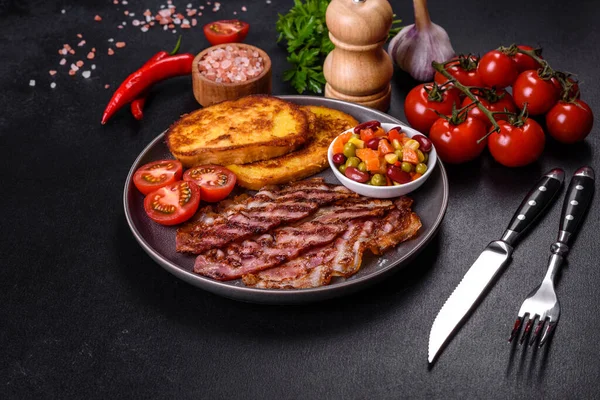 Lezzetli ızgara pastırma dilimleri, baharatlı, tuzlu, sebzeli ve çimento kaplı arka planda kızartılmış yumurta ve kızarmış ekmek.