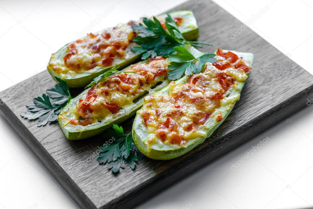 Zucchini stuffed with meat, vegetables and cheese. Zucchini boats. Loaded zucchini